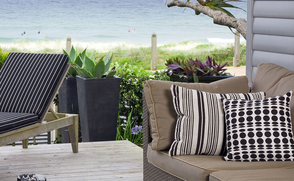 Outdoor patio with furniture and beach view